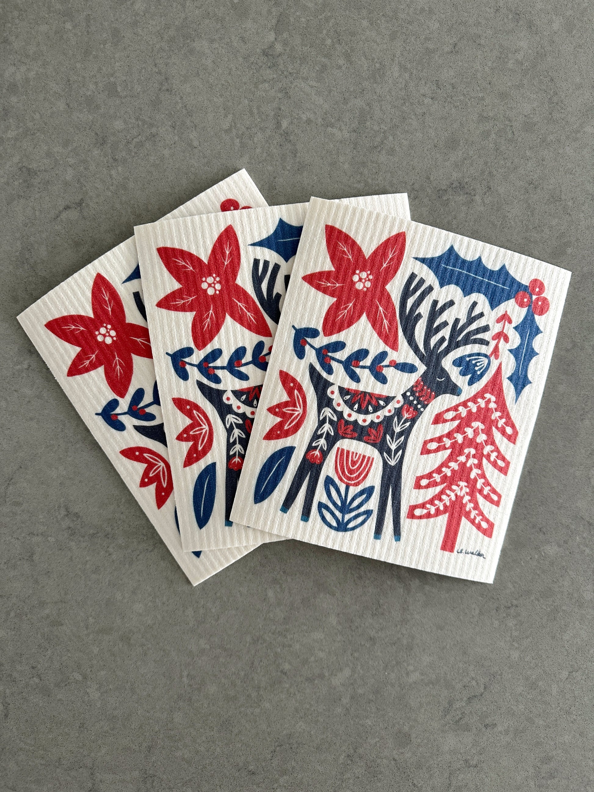 3 dishcloths with a folk art reindeer design.